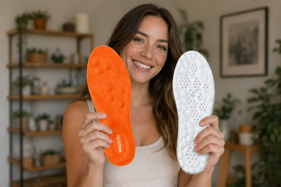 Walkvio customer holding orange massage insole and white memory-foam insole at home