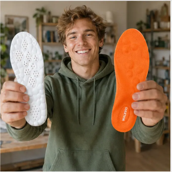 Young man in green hoodie comparing Walkvio orange massage insole and white insole